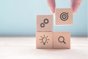 Stacked wooden blocks with key social components as icons on the blocks